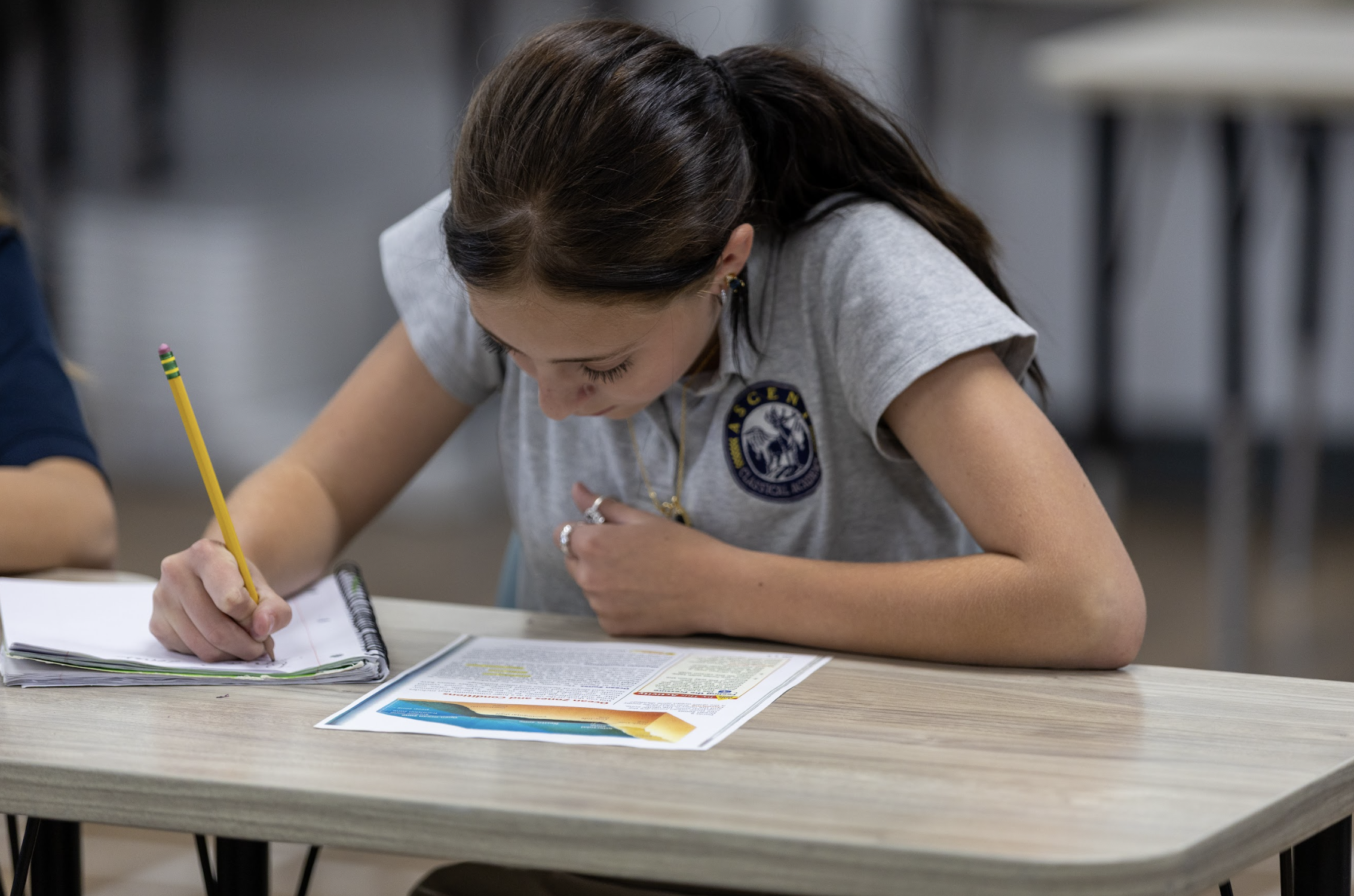 Laughing students sitting at their desks.