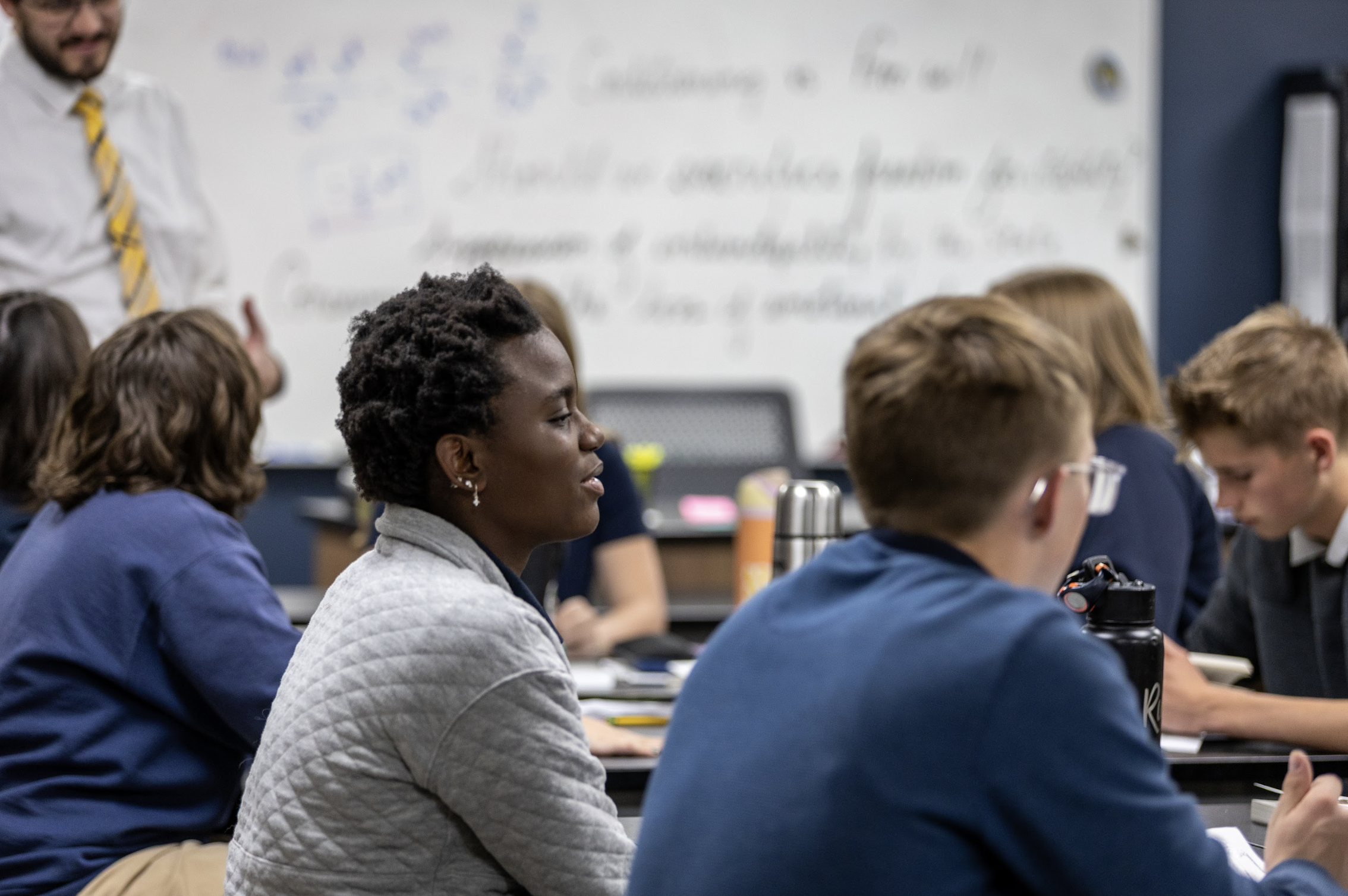 Laughing students sitting at their desks.