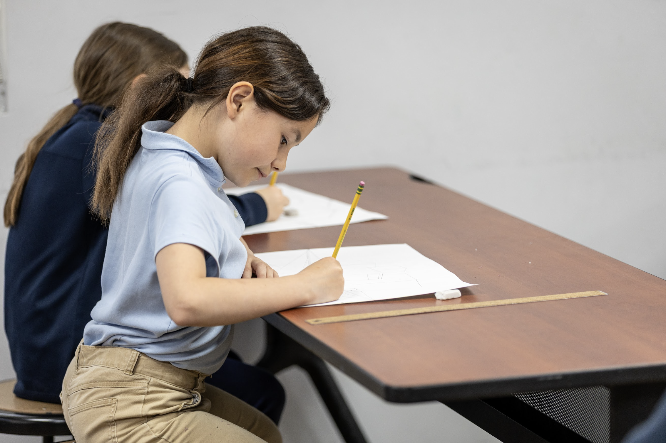 Laughing students sitting at their desks.